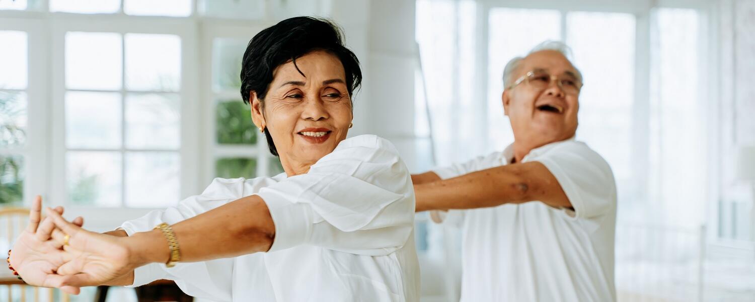 Two older people doing dance exercise 