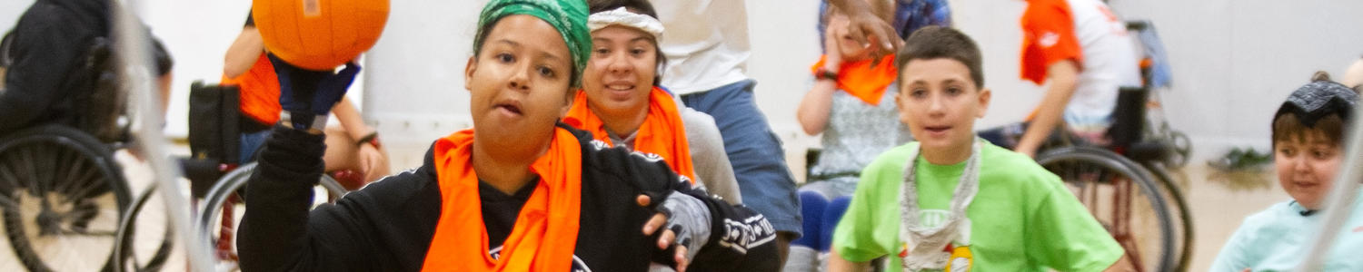 Kids in wheel chairs playing ball 