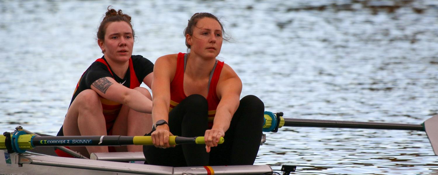 Claire O'Brien [left] and Eliza Dawson [right] row for UCalgary at the first Dino's Sprints Regatta race since COVID restrictions were lifted in September 2021. 