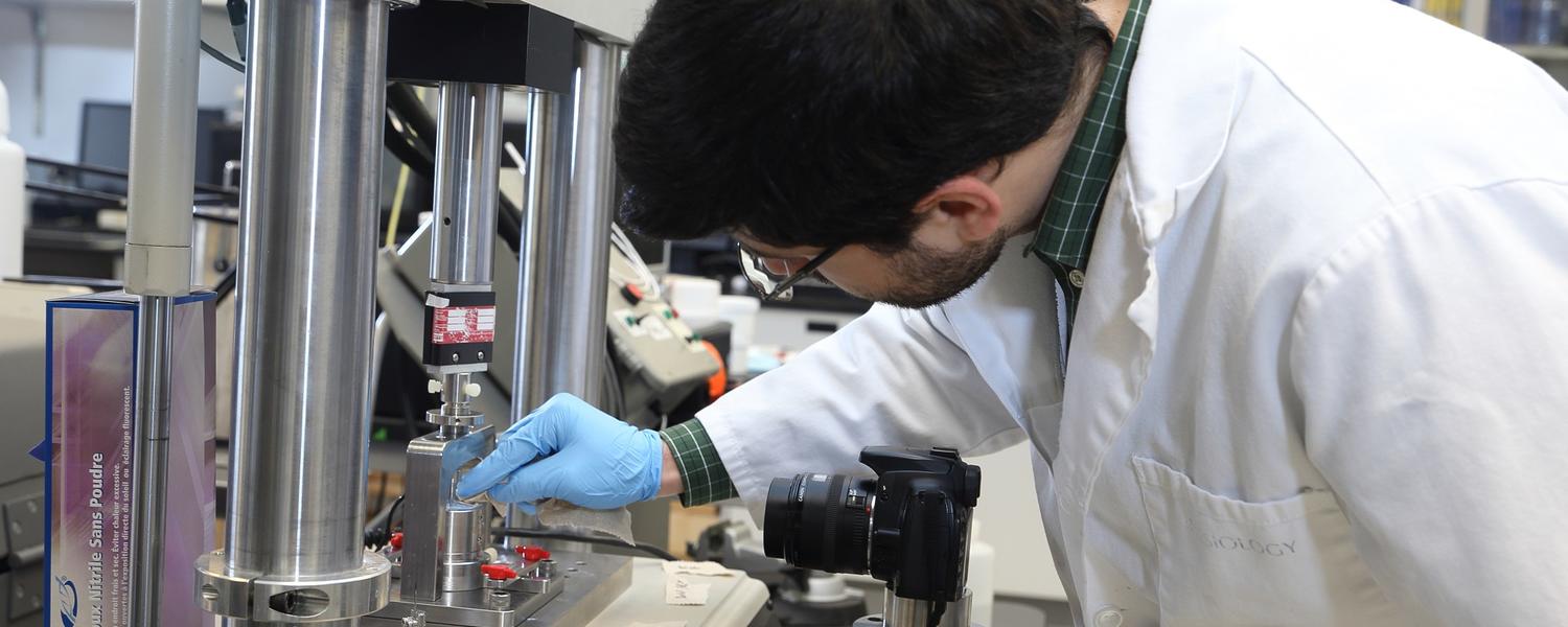 Student in the lab working with machine