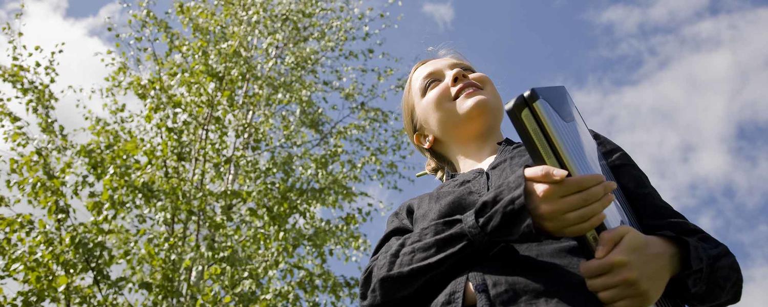 Student in sun with laptop