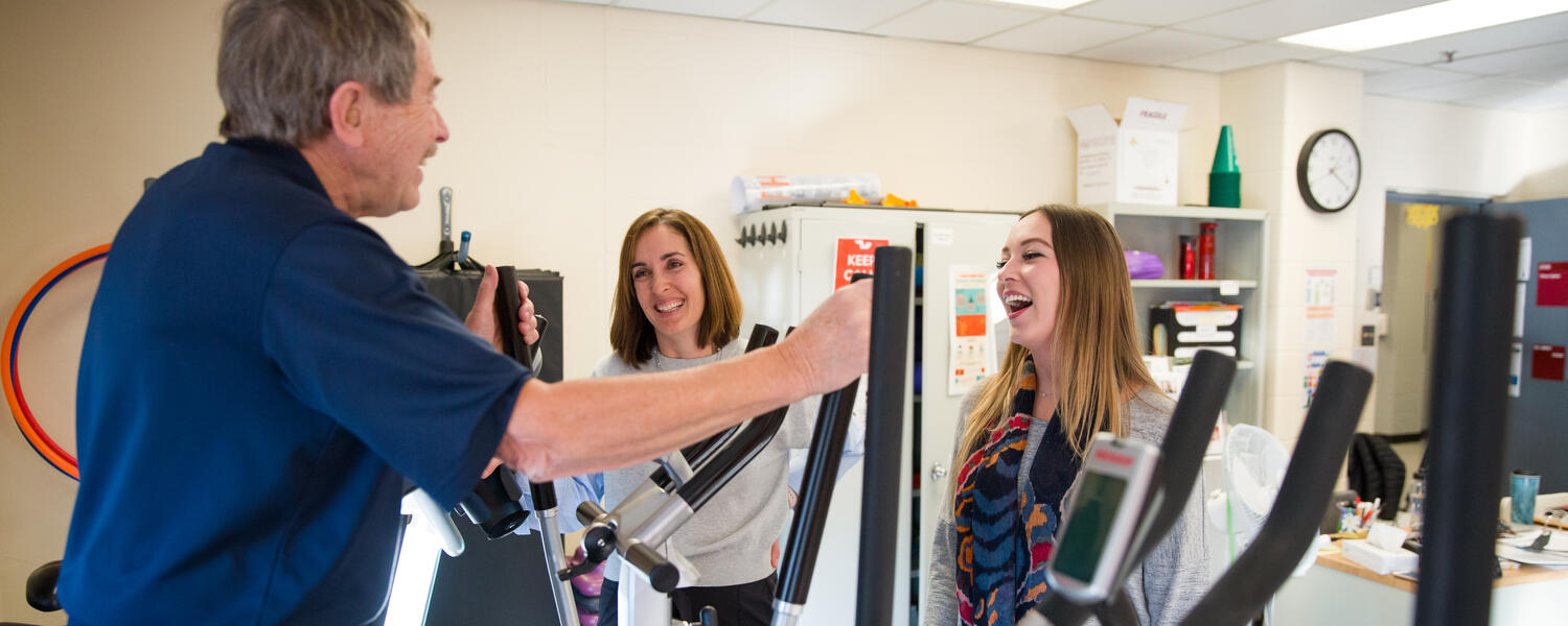 two researchers helping man fitness
