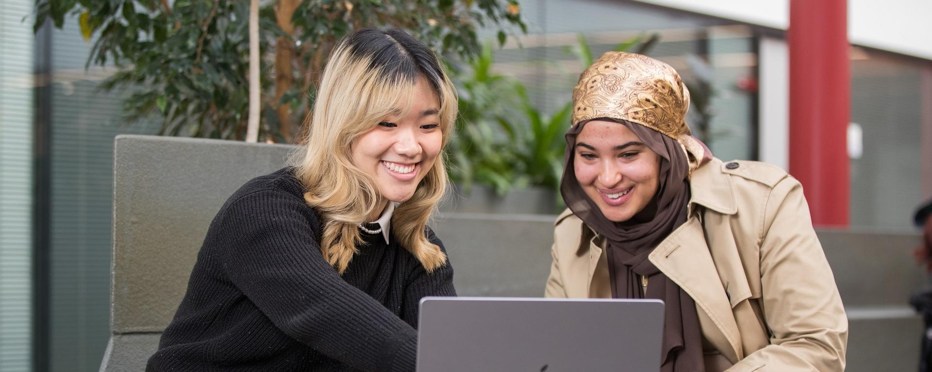 Two undergrad students in the Kinesiology atrium