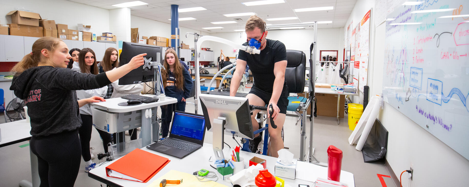 Person demonstrating equipment to group of students