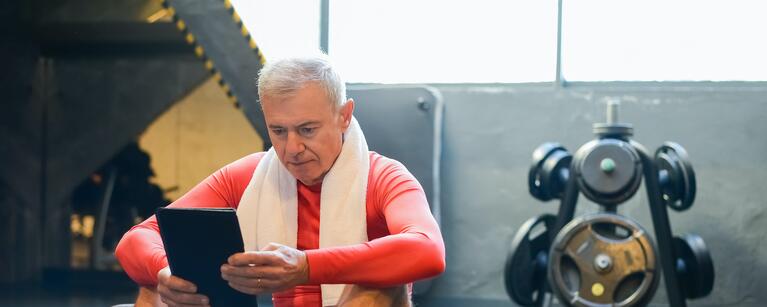 man sitting on yoga mat