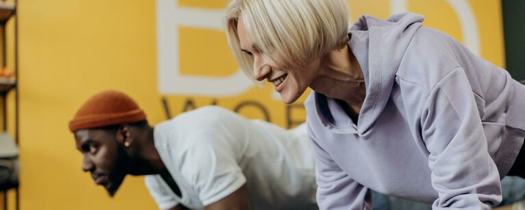 A man and women working out beside one another 