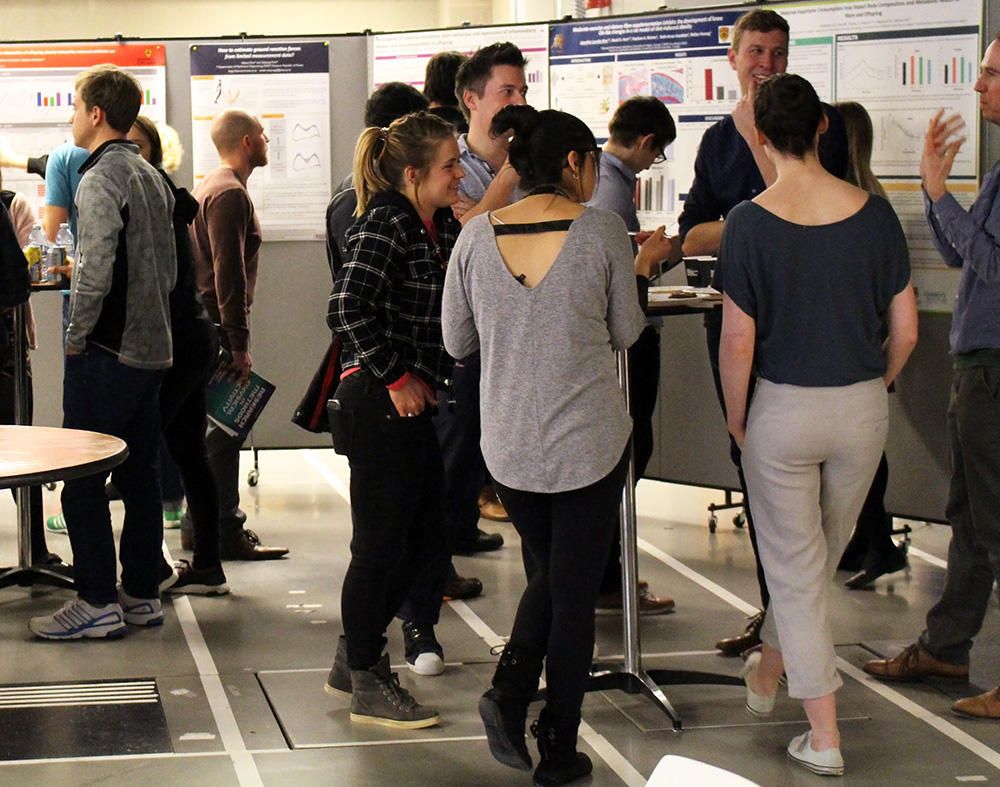 Graduate students visiting at an event in the Human Performance Lab