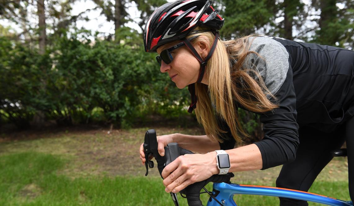 Woman cycling with smartwatch