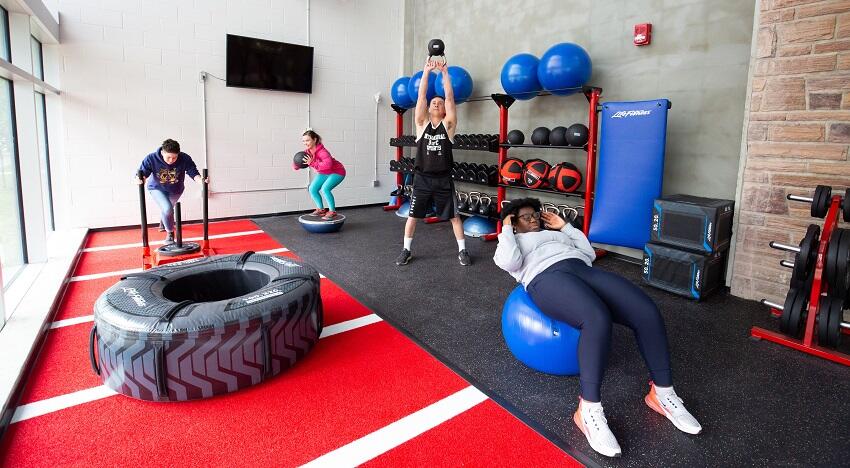 people working out in the gold alcove gym at UofC