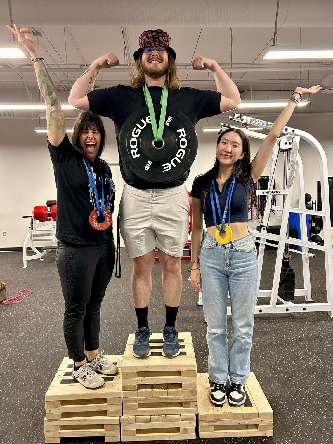 Alana, Pat, and Leah standing on a podium