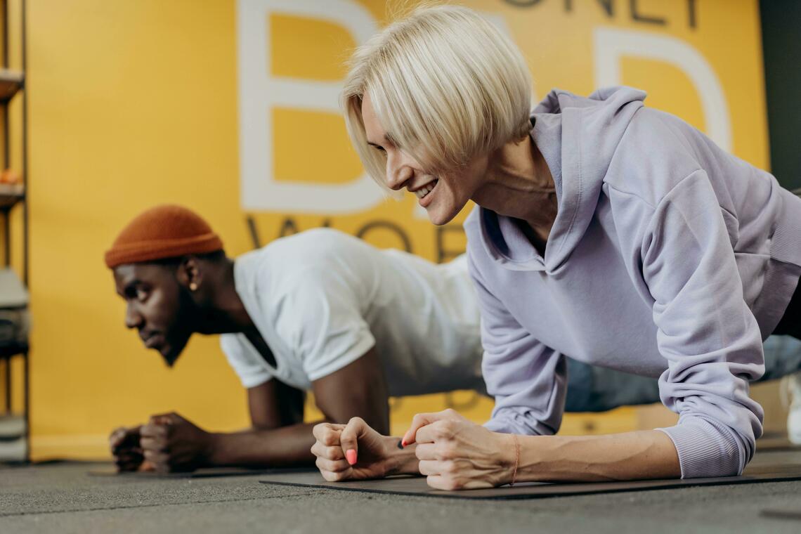 A man and woman working out beside one another