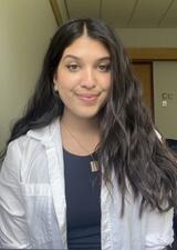 A headshot of Mahrukh smiling at the camera in the relationships and exercise lab.