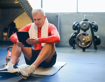 older man sitting on yoga mat